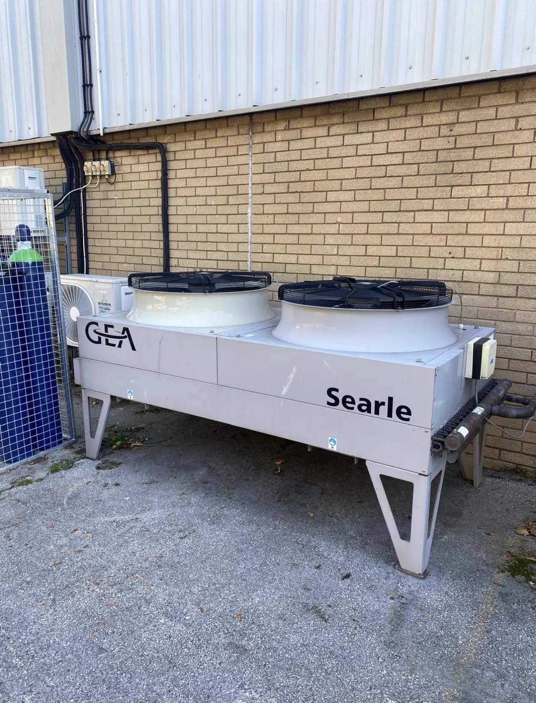 Large outdoor equipment beside an industrial building